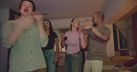 Friends dancing together and enjoying drinks at a house party. The party atmosphere is vibrant, with colorful lights, music, and energetic dancing.