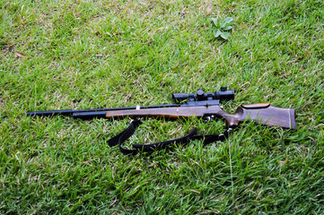 a rifle on the green grass