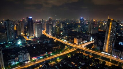 Obraz premium Aerial View of Illuminated Bangkok Cityscape at Night with Skyscrapers and Highway with Long Exposure