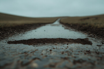 A road with a puddle in the middle