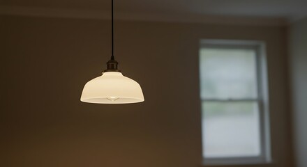 Modern Pendant Light Fixture Illuminating Minimalist Interior Space with Window