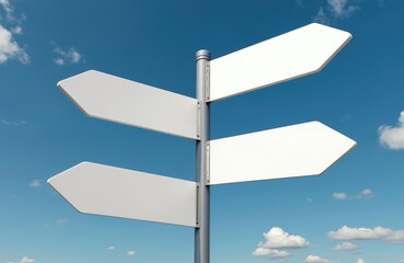 Four blank white road signs point different directions against clear blue sky with clouds. Signposts offer navigation guidance, choice direction decision. Empty pointers provide empty signboard