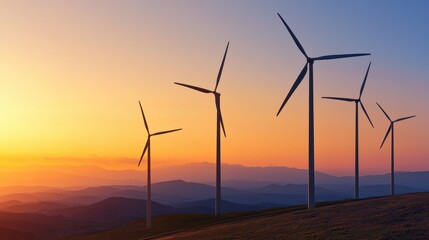 Fototapeta premium Wind turbines at sunset. Wind farm on a hill generating clean, green, renewable energy. Concept of sustainability and environmental awareness.