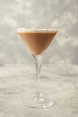 Coffee liqueur based cocktail in martini glass on the rustic background. Selective focus. Shallow depth of field.