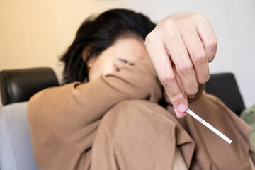 Close-up of young woman holds a pregnancy test in her hands. Positive pregnancy test.