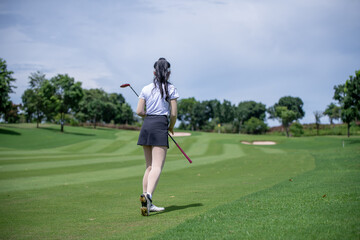 Obraz premium Golfer stance and swing demonstrate skill and control, reflecting the precision required in the sport game and the scenic landscape of a premium golf course.
