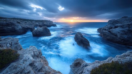Dramatic sunset over rocky ocean coast.