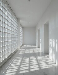Obraz premium A long white hallway is lit by natural sunlight and shadows