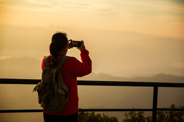 Woman traveler with backpack hiking outdoor travel lifestyle and adventure concept. cap backpack and join of tourist for green mountain tour, beauty of nature and expansive sky people of tourism