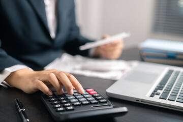Finance bank tax expense accounting budget money businessman hand use calculator Financial...