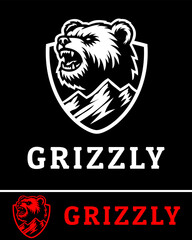 Obraz premium A fierce grizzly bear logo featuring a roaring bear head inside a shield with mountain elements