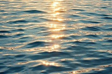 Sunlight reflects on calm water surface creating shimmering patterns during a serene day by the sea