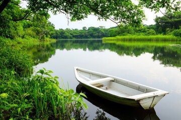 Obraz premium Serene boat ride amidst tranquil water and lush green forest scenic summer landscape