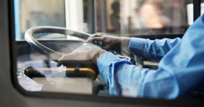 Bus driver, hands and man with public transportation, commute and traffic. Person, closeup and employee for city, steering wheel and morning route for pickup, urban journey or service in New York