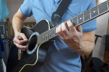Fototapeta premium Man plays an acoustic guitar