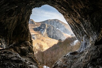 Cave View to Rugged Mountains