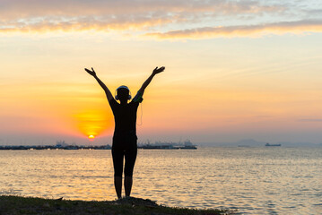 Silhouette lifestyle woman yoga exercise for healthy life.  People pose balance body vital zen and meditation workout and fitness sport outdoor sunset near the beach