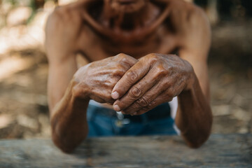 Fototapeta premium Close up of male wrinkled hands, old man is wearing ..