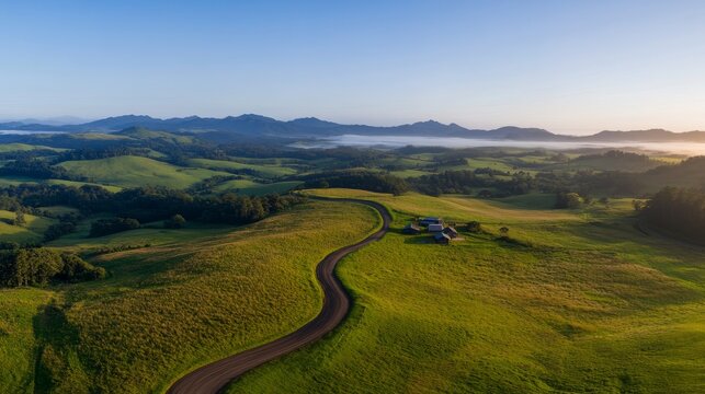 Jagged mountain peaks emerge through flowing mist at dawn, bathed in golden light. The sky shifts from deep indigo to soft pastels, creating a breathtaking panorama