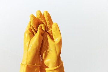 Pair of yellow rubber gloves on white background with copy space
