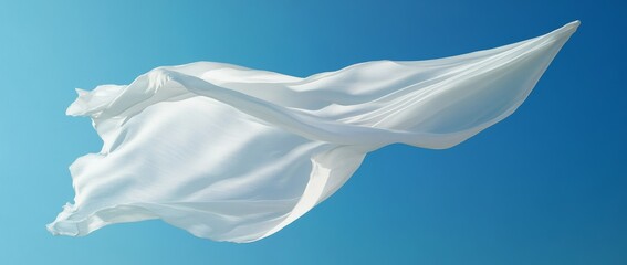 Obraz premium White flag fluttering in the wind against a clear blue sky highlighting soft folds and texture