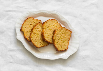 Slices of ricotta lemon cake on a white plate on a light background
