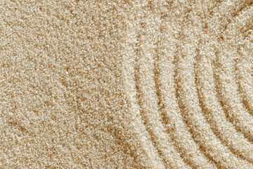 Top view pattern in Japanese Zen Garden with close up concentric circles on sand for meditation and relaxation. Aesthetic minimal sandy background with copy space, beige monochrome neutral tones