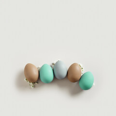 Pastel Easter Eggs as minimal pattern with white blooming Flowers on beige color, top view colorful chicken egg. Easter celebration concept. Festive food, still life holiday, aesthetic flat lay