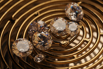 Beautiful shiny gemstones on golden tray, closeup