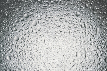 Water drops on grey glass surface, top view