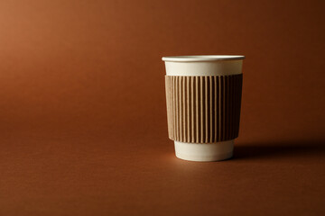 One paper cup on brown background. Mockup for design