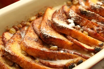 Freshly baked bread pudding in baking dish, closeup