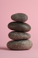 Stack of rocks on pink background. Harmony and life balance