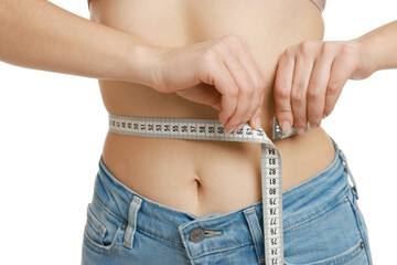 Woman measuring waist circumference on white background, closeup