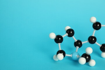 Chemical model of molecule on light blue background, closeup. Space for text