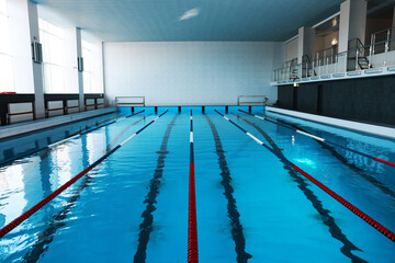 Swimming pool with clean water and lane dividers indoors