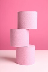 Color toilet paper rolls on pink background