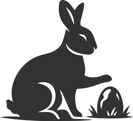 A rabbit pawing at a small stone animal silhouette