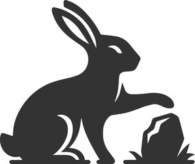 A rabbit pawing at a small stone animal silhouette