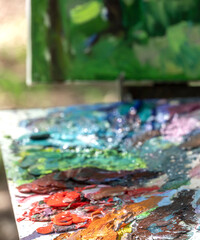 Painting is displayed on a table with a variety of colors