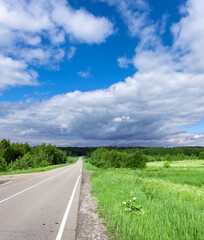 Road with a grassy field on the side
