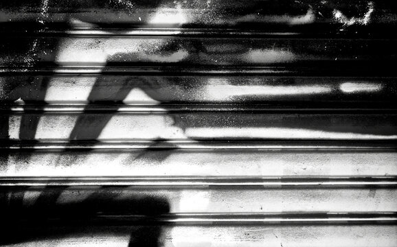 Fototapeta Abstract spray painting on metal door wall background. Rustic and grunge texture urban. Street and Fashion. Black and white color. Close up.