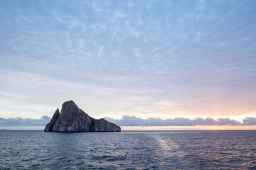 The volcanic rock formation of Kicker Rock (Leon Dormido) at sunset in the Pacific Ocean. Galapagos National Park, Ecuador.	