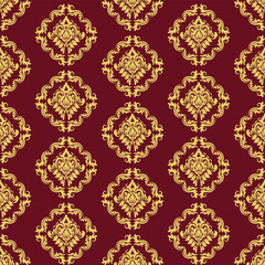 Seamless damask pattern. Damask fabric pattern with gold motifs on a deep red background. The repeating pattern creates a classic, luxurious and elegant feel.