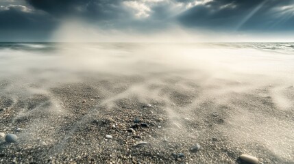 Serene Ocean Waves Gently Lapping Against Textured Sandy Shore Under Dramatic Cloudy Sky