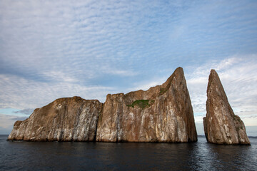 The volcanic rock formation of Kicker Rock (Leon Dormido) at sunset in the Pacific Ocean. Galapagos...