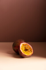 Whole and cut in half passion fruit or maracuya with edible center of juicy pulpy yellow seeds on...