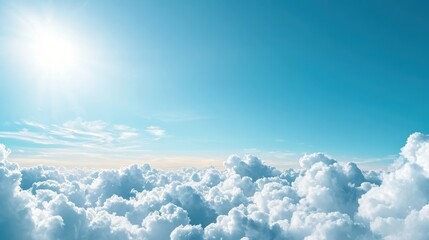 Fototapeta premium A bright, clear blue sky dotted with small, fluffy white cumulus clouds, casting soft shadows on the landscape below, evoking a sense of peace and tranquility.
