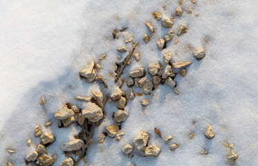 A rocky, snowy field with a few small rocks scattered around