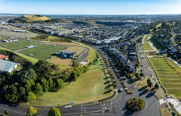 Aerial view of a sports complex and residential neighborhood. Parks, fields, and homes are visible. Urban development in progress. ST JOHNS, AUCKLAND, NZ